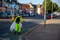 08/02/2020 Portsmouth, Hampshire, UK A council worker in high visibility clothing litter picking in the street