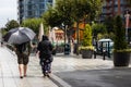 A couple walking in the rain, the lady is holding an upbrella