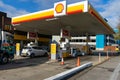 The exterior of a shell fuel garage with cars on the forecourt