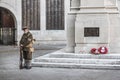 09/14/2019 Portsmouth, Hampshire, UK A man in World war one soldiers uniform standing next to a British war memorial with red