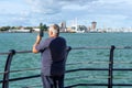 10/09/2019 Portsmouth, Hampshire, UK A middle aged man taking a picture at the seaside using his mobile phone or cell phone