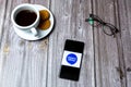 03-10-2021 Portsmouth, Hampshire, UK A Mobile phone or cell phone laid on a wooden table with the Citizens advice bureau logo on Royalty Free Stock Photo