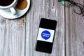 03-10-2021 Portsmouth, Hampshire, UK A Mobile phone or cell phone laid on a wooden table with the Citizens advice bureau logo on Royalty Free Stock Photo