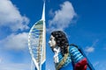 An old figurehead from a ship with the spinnaker tower in Portsmouth in the background