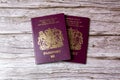 02-08-2021 Portsmouth, Hampshire, UK a pair Of British passports laid on a wooden table Royalty Free Stock Photo