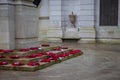 Poppy wreaths laid around a war memorial on remembrance day Royalty Free Stock Photo