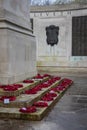 Poppy wreaths laid around a war memorial on remembrance day Royalty Free Stock Photo