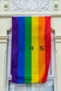 04/30/2020 Portsmouth, Hampshire, UK A rainbow flag with the letter NHS on it flying on the front window of a house in support Royalty Free Stock Photo