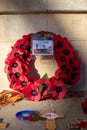 11/11/2019 Portsmouth, Hampshire, UK A red poppy wreath laid in front of a war memorial on remembrance day