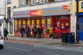 04/30/2020 Portsmouth, Hampshire, UK shoppers performing social distancing while queuing outside an Iceland supermarket During the