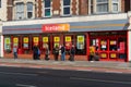 04/30/2020 Portsmouth, Hampshire, UK shoppers performing social distancing while queuing outside an Iceland supermarket During the