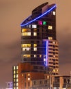 A tall modern apartment block lit up at night Royalty Free Stock Photo