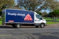 A Tesco grocery delivery van on the road with freshly clicked written on the side of the van