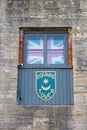 08-12-2021 Portsmouth, Hampshire, UK a window in the Square Tower in Old Portsmouth with a union jack and the portsmouth crest bel