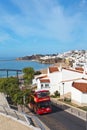 Portugal. Algarve. Red tourist bus carries tourists through the old town of Albufeira