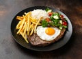 Portugal dish Bitoque made from beef steak with a fried egg, rice, french fries and vegetables Royalty Free Stock Photo