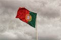 Portugal flag waving under cloudy sky Royalty Free Stock Photo