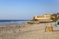 People enjoy a relaxing afternoon at the golden Praia das Macas on the Atlantic Ocean