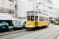 Portugal, Lisbon, 01 July 2018: An old-fashioned vintage traditional yellow tram moving along the city street of Lisbon Royalty Free Stock Photo