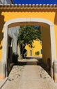 Portugal, Lisbon, Oeiras. Typical old arched gateway and yellow facade Royalty Free Stock Photo