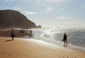 Portugal. Algarve. Seascape sandy ocean shore at Castelejo beach with silhouettes of people