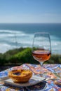 Portugal`s traditional food and drink, glass of porto wine or muscatel de setubal and sweet dessert Pastel de nata egg custard