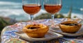 Portugal`s traditional food and drink, glasses of porto wine or muscatel de setubal and sweet dessert Pastel de nata egg custard