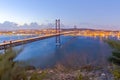 Portugal Travel Destinations. Crossing The Tagus River. Amazing Image of Lisbon Cityscape Along with 25th April Bridge Ponte 25 Royalty Free Stock Photo