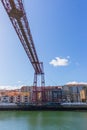 Biscay bridge flying with gondola over river Nervion. Portugalete landmark. Famous bridge called Puente de Vizcaya near Bilbao. Royalty Free Stock Photo