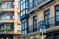 Information sign for pilgrims on the St. James Way and colorful facades in the old town of Portugalete, Spain