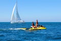 Lifeguards on Jet Ski, Rescue Team, Attractive Young Woman and Man, Background Yacht Scenery Royalty Free Stock Photo