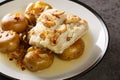 Portuguese Bacalhau a Lagareiro salted cod baked in oil with potatoes close-up in a plate. horizontal