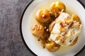 Portuguese Bacalhau a Lagareiro salted cod baked in oil with potatoes close-up in a plate. horizontal top view