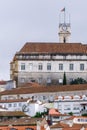 Portuguese city with white buildings and red-tiled roofs on a hill