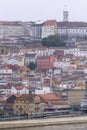 Portuguese city with white buildings and red-tiled roofs on a hill