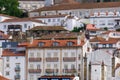 Portuguese city with white buildings and red-tiled roofs on a hill