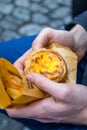 Portuguese Dessert Egg Tart (Pasteis de Nata) in Man's Hand, Close-up