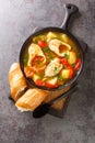 Portuguese fish stew Caldeirada de Peixe close-up in a bowl. Vertical top view