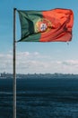 Portuguese flag with Cascais, Portugal in the background next to the sea Royalty Free Stock Photo