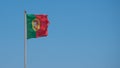 Portuguese flag flying from a flagpole in Porto