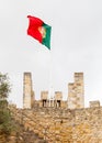 The Portuguese Flag is Pictured Over Sao Jorge Castle Royalty Free Stock Photo