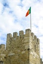 Portuguese flag waving on tower of Sao Jorge Castle. Lisbon, Portugal Royalty Free Stock Photo