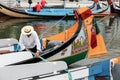 Portuguese sailor mooring traditional moliceiro boat in Aveiro,