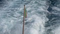 Portuguese Waving Flag in the stern of a ship. View from a boart