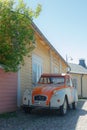 Porvoo, Finland - 3 June 2020: Beautiful street with blooming white lilac and vintage car Citroen 2CV in old town of Porvoo Royalty Free Stock Photo