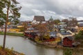 Old red wooden houses on the river coast on a cloudy day Royalty Free Stock Photo