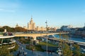 Poryachiy bridge over Moskva river at Zaryadye Park, the boat on the river and Kotelnicheskaya Stalin`s Skyscraper. Royalty Free Stock Photo