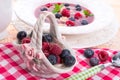 Porzelan basket with raspberry and bilberry