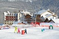 Posa Khutor, Sochi, Russia, January, 26, 2018. Instructor and little boy skiing on the child`s training slope in the background of