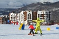 Posa Khutor, Sochi, Russia, January, 26, 2018. The instructor teaching little boy to go skiing on the child`s training slope in th